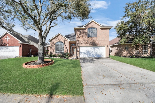 traditional-style house featuring a garage, driveway, and a front yard