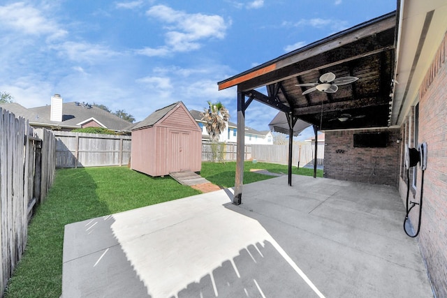 view of patio / terrace with an outbuilding, a fenced backyard, a storage unit, and ceiling fan