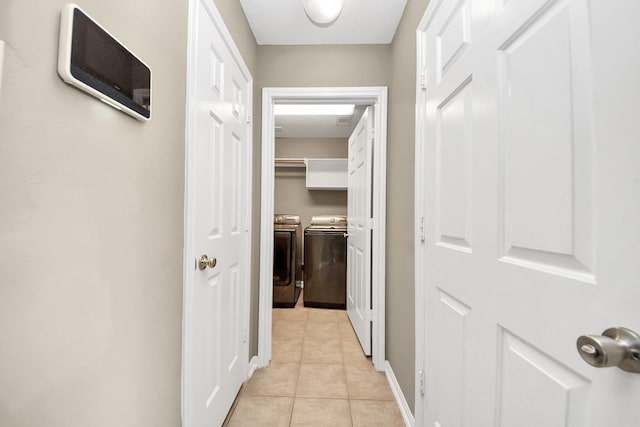 hallway featuring light tile patterned floors and independent washer and dryer