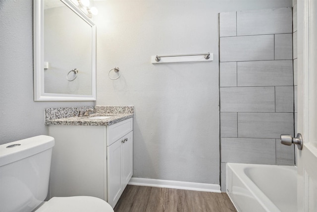 full bath with toilet, vanity, baseboards, and wood finished floors