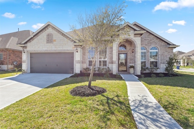 view of front of home featuring brick siding, an attached garage, driveway, and a front lawn