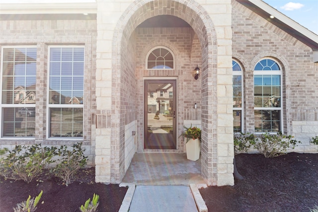 doorway to property with brick siding