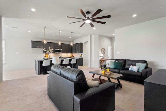 living room featuring visible vents, light tile patterned flooring, recessed lighting, ceiling fan, and light colored carpet