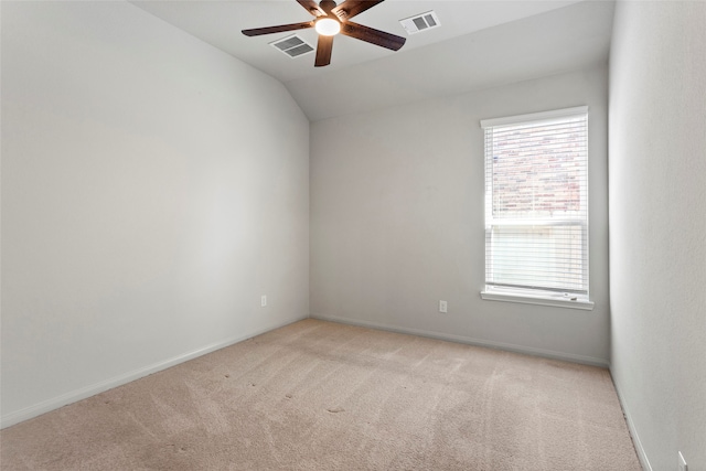 empty room with visible vents, light carpet, and ceiling fan