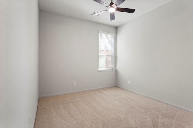 empty room featuring baseboards, carpet floors, and a ceiling fan