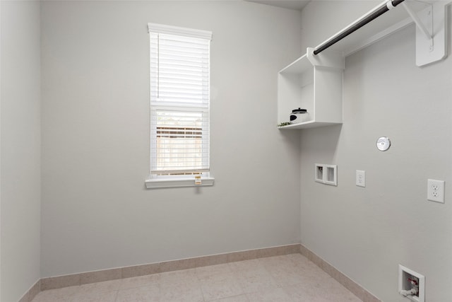 clothes washing area featuring washer hookup, laundry area, light tile patterned floors, and baseboards