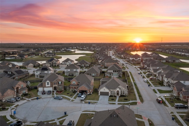 aerial view at dusk featuring a residential view