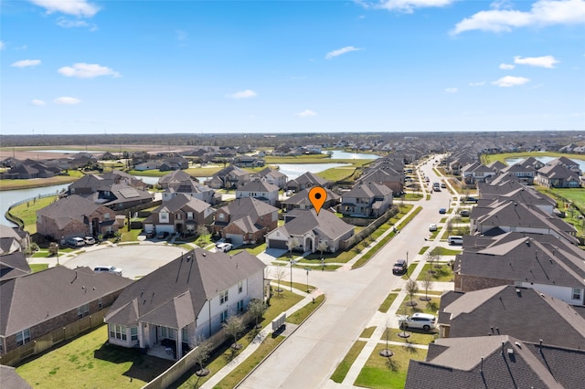 bird's eye view featuring a residential view and a water view