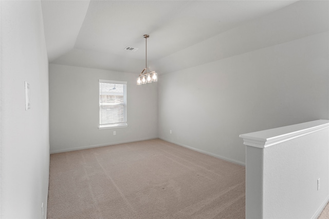 spare room with visible vents, a notable chandelier, baseboards, light colored carpet, and vaulted ceiling