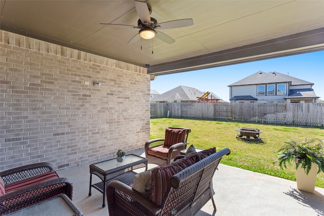 view of patio / terrace with an outdoor living space with a fire pit, ceiling fan, and fence