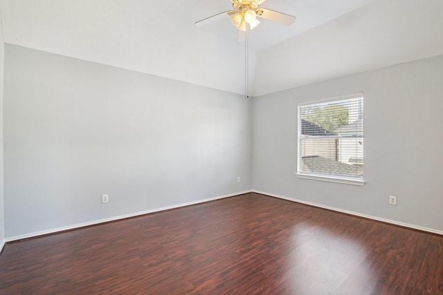 spare room with dark wood finished floors, baseboards, a ceiling fan, and vaulted ceiling