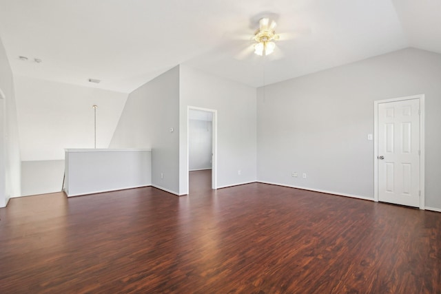 empty room with vaulted ceiling, visible vents, dark wood-style flooring, and ceiling fan