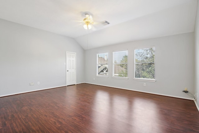 unfurnished room featuring visible vents, lofted ceiling, a ceiling fan, and dark wood-style flooring