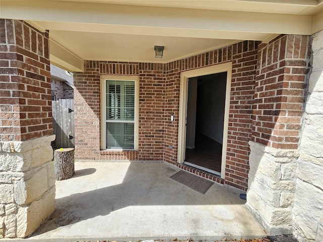 property entrance featuring brick siding