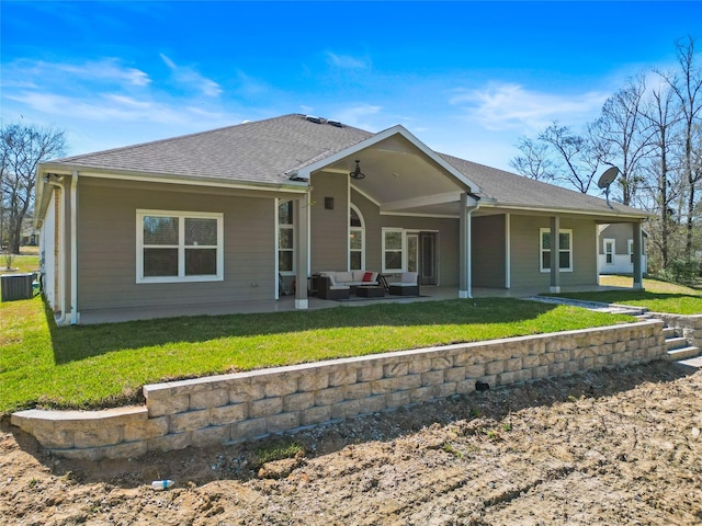 back of property with outdoor lounge area, central air condition unit, a yard, and a patio area