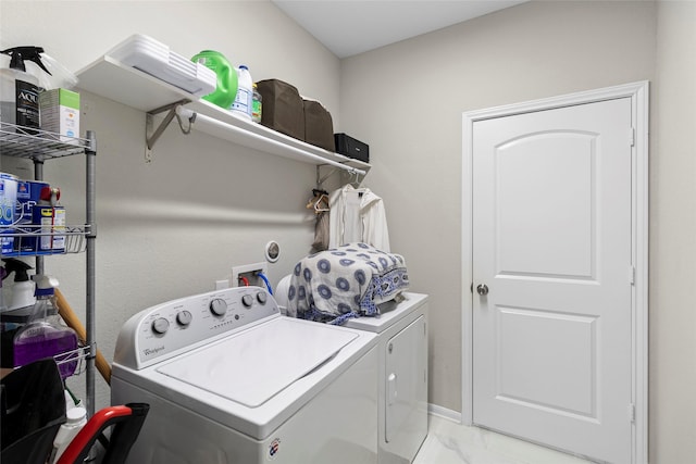 clothes washing area with marble finish floor, laundry area, and washing machine and clothes dryer