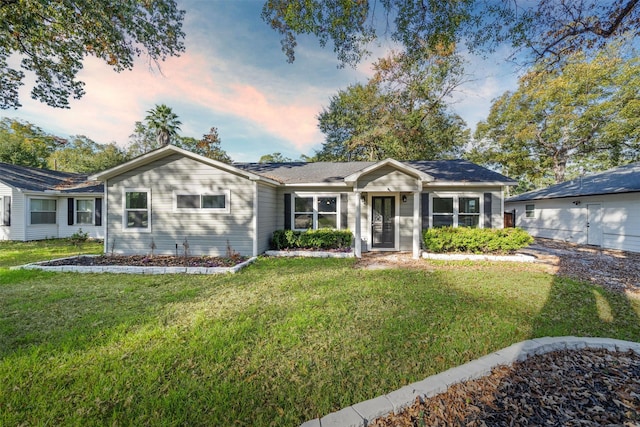 ranch-style house featuring a yard