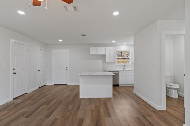 kitchen with visible vents, dishwasher, and white cabinets