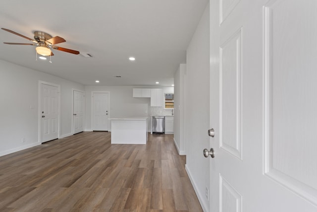 unfurnished living room with recessed lighting, visible vents, baseboards, and wood finished floors