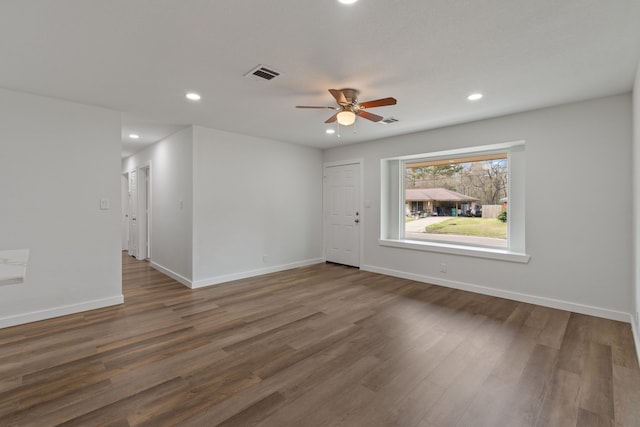 empty room featuring recessed lighting, visible vents, baseboards, and wood finished floors