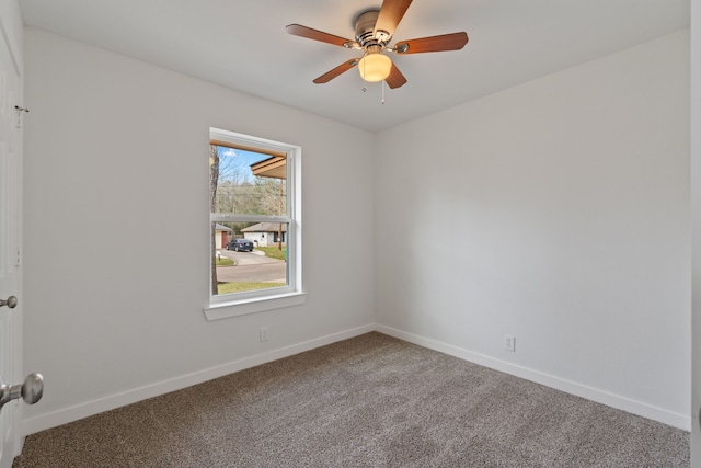 spare room with baseboards, carpet floors, and ceiling fan