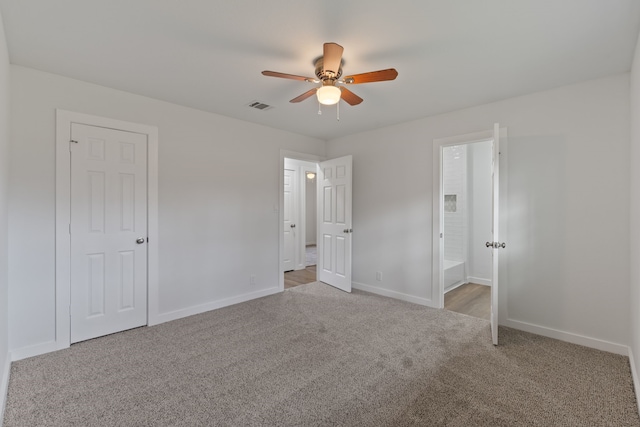 unfurnished bedroom featuring visible vents, a ceiling fan, baseboards, and carpet floors