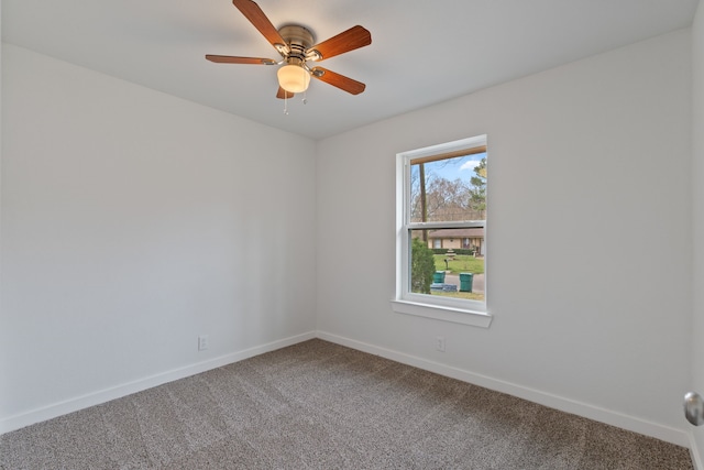 spare room with baseboards, carpet floors, and a ceiling fan