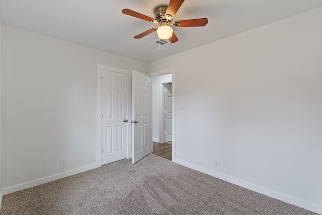 unfurnished room featuring visible vents, ceiling fan, baseboards, and carpet floors