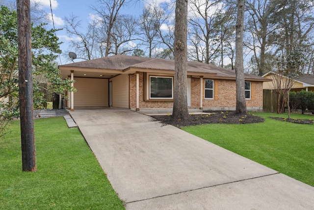 ranch-style house with an attached carport, a front yard, fence, concrete driveway, and brick siding