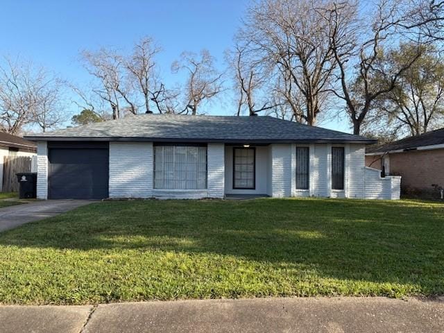 ranch-style house with brick siding, an attached garage, driveway, and a front lawn