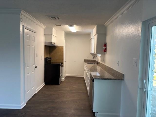 kitchen with dark countertops, a sink, electric range oven, white cabinetry, and dark wood-style flooring