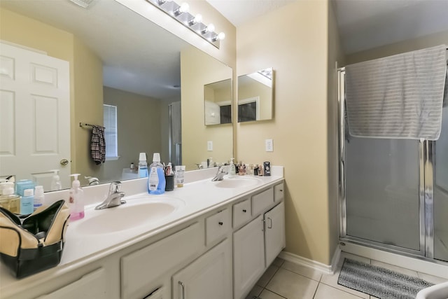 full bathroom with tile patterned floors, double vanity, a shower stall, and a sink