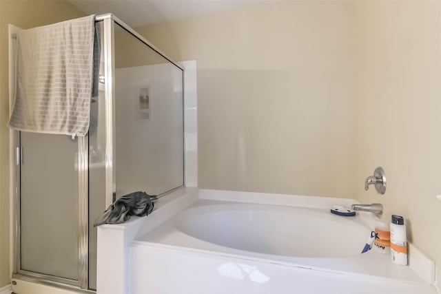 bathroom featuring a garden tub and a stall shower