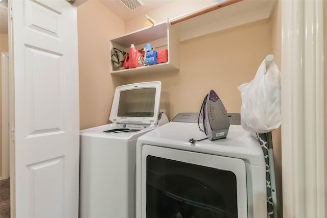 clothes washing area with laundry area, independent washer and dryer, and visible vents