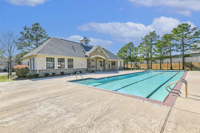 community pool featuring a patio area and fence