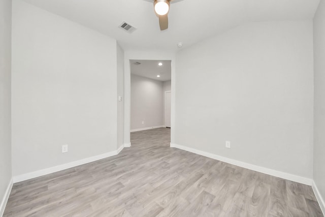 spare room featuring light wood finished floors, visible vents, ceiling fan, and baseboards