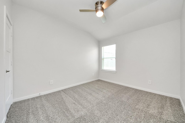 empty room featuring baseboards, carpet floors, lofted ceiling, and ceiling fan