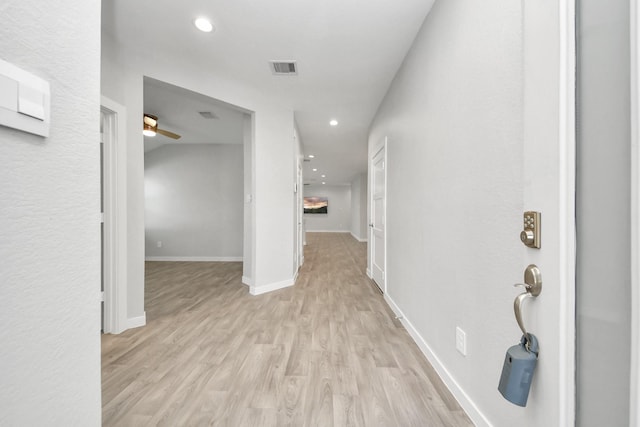 hall with visible vents, recessed lighting, baseboards, and light wood-style floors