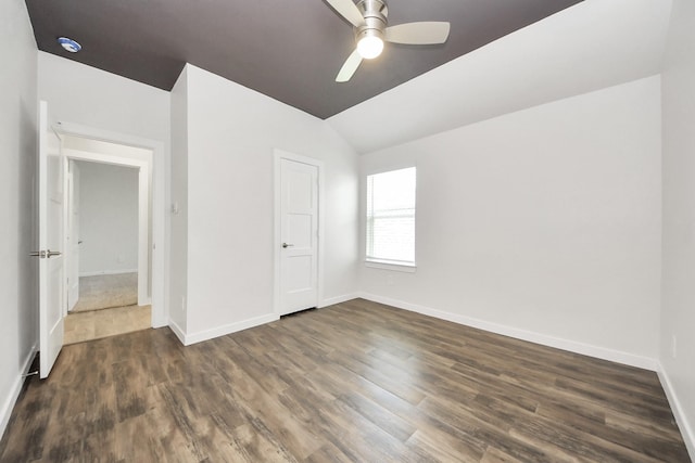 unfurnished bedroom featuring lofted ceiling, wood finished floors, baseboards, and ceiling fan