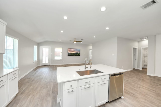 kitchen with visible vents, open floor plan, light countertops, stainless steel dishwasher, and a sink