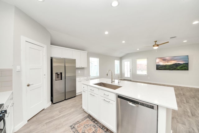 kitchen featuring recessed lighting, a sink, light countertops, white cabinets, and appliances with stainless steel finishes