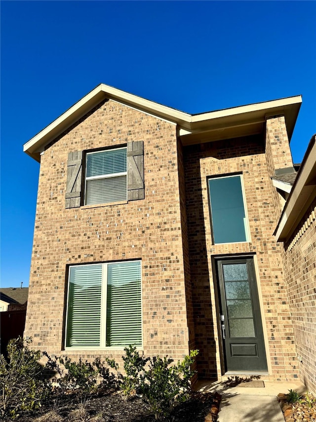 view of front of home featuring brick siding