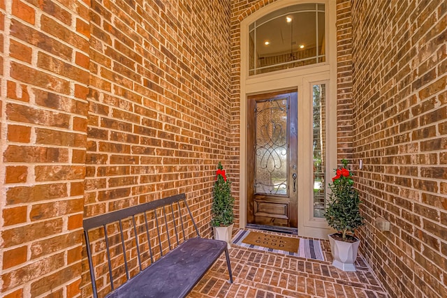 property entrance featuring brick siding