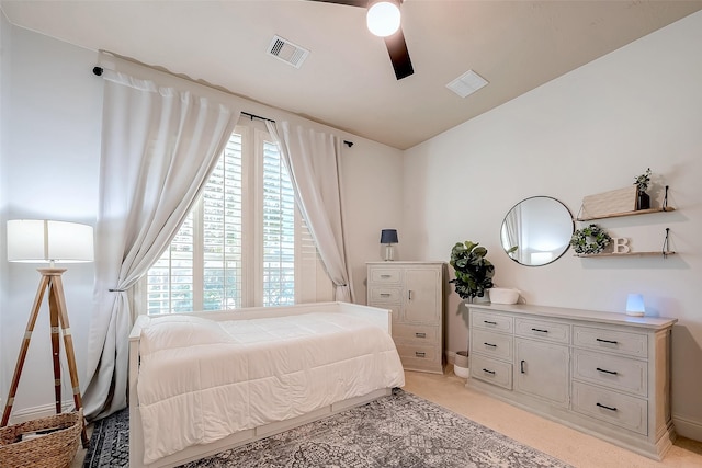 bedroom featuring light carpet, visible vents, and ceiling fan