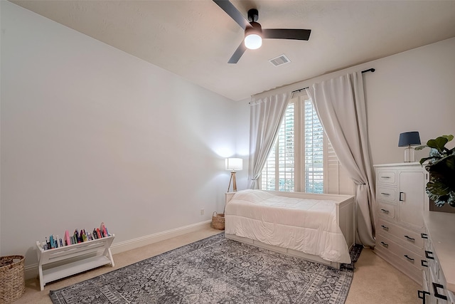 bedroom featuring visible vents, baseboards, light colored carpet, and ceiling fan