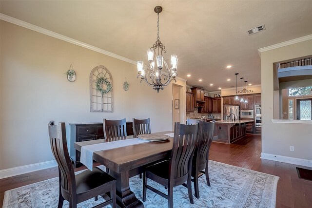 dining space with baseboards, dark wood-style floors, visible vents, and ornamental molding