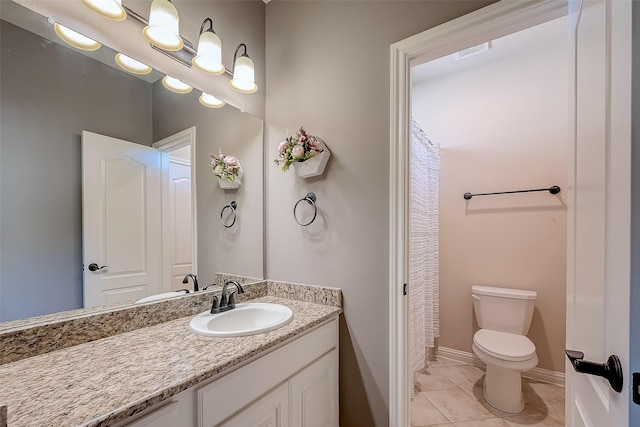 bathroom featuring vanity, visible vents, baseboards, tile patterned flooring, and toilet