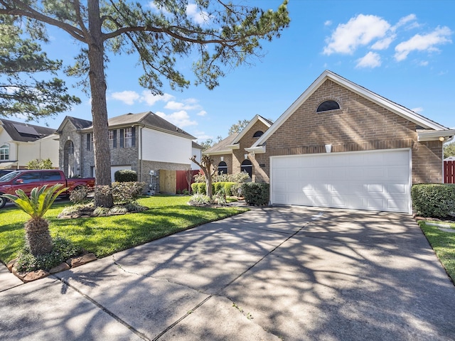 view of front facade with a garage, brick siding, concrete driveway, and a front yard