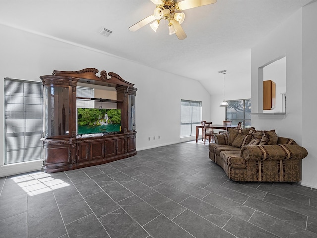 living area featuring baseboards, visible vents, dark tile patterned flooring, ceiling fan, and vaulted ceiling