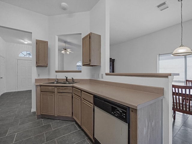 kitchen featuring visible vents, light countertops, a peninsula, white dishwasher, and a sink